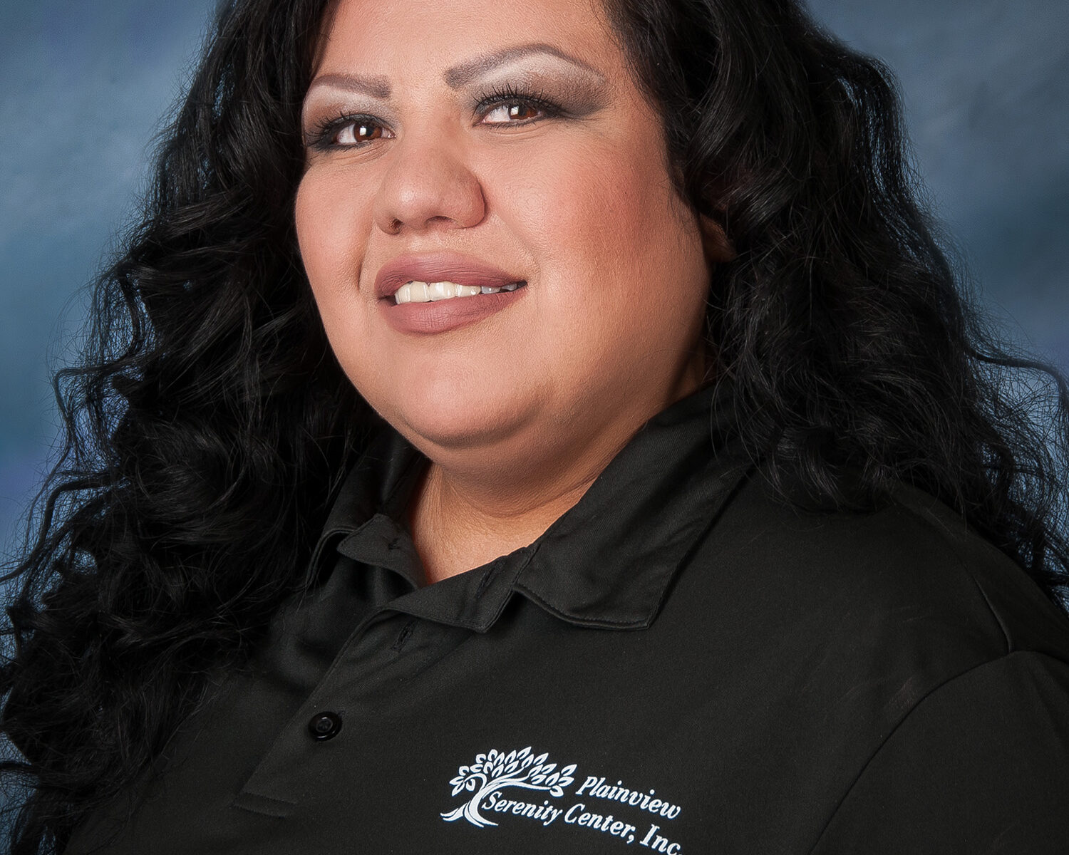 Portrait of smiling woman in black polo