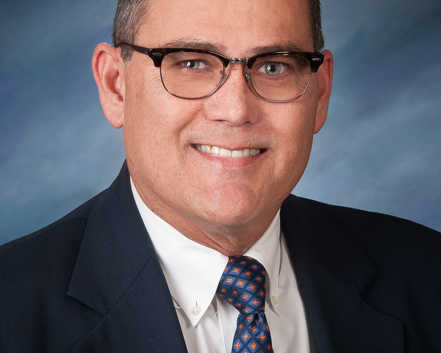 Smiling middle-aged man wearing suit and glasses