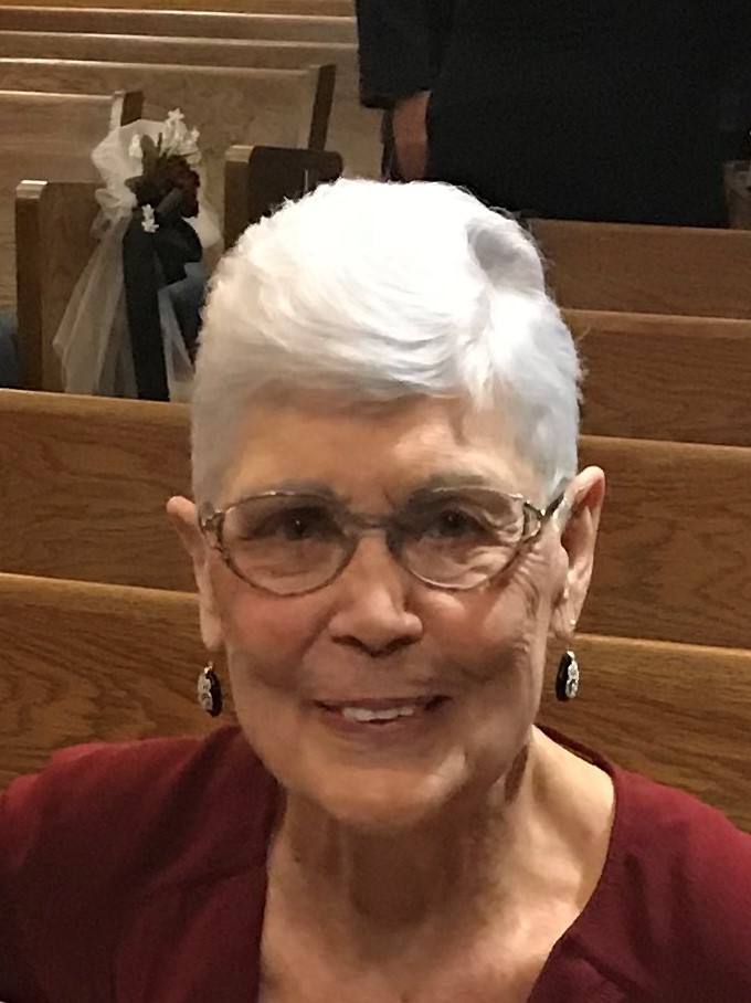 Older woman with white hair wearing glasses